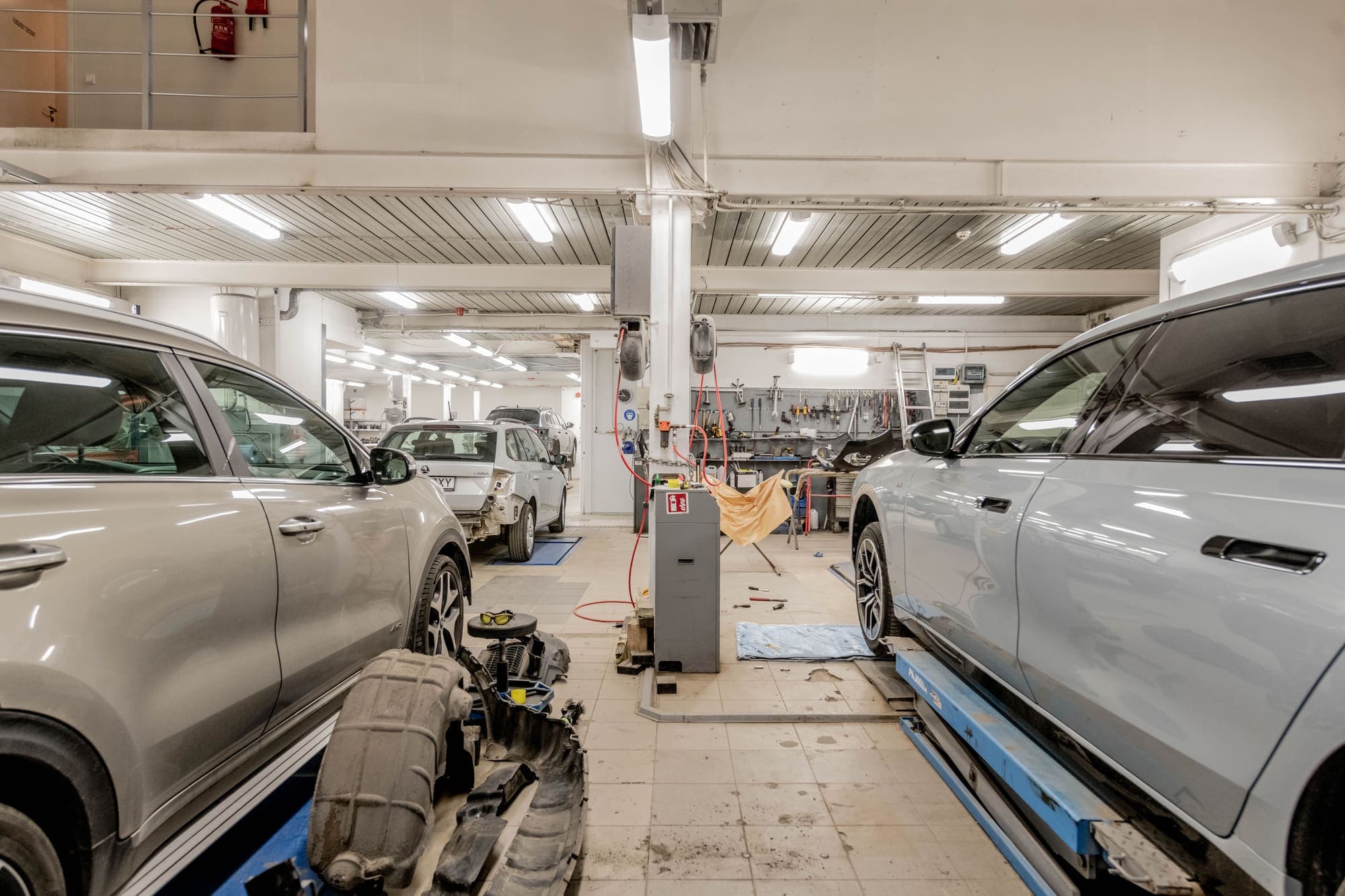 Vehicle on a lift inside a dealer service bay.